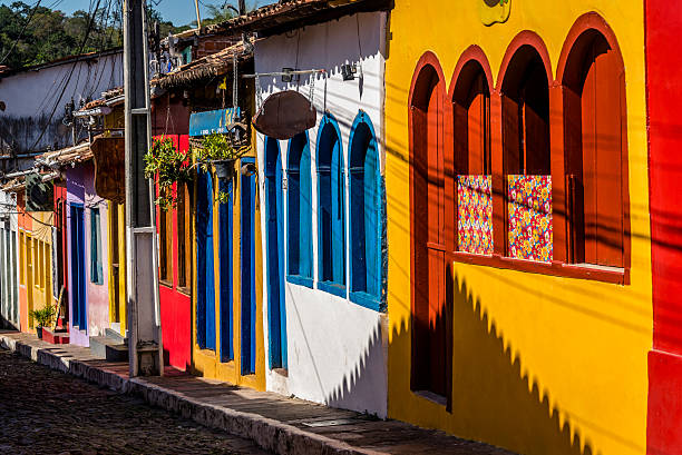 Vista de Lençóis, Bahia, com casas coloniais coloridas emolduradas por vegetação da Chapada Diamantina sob céu azul.